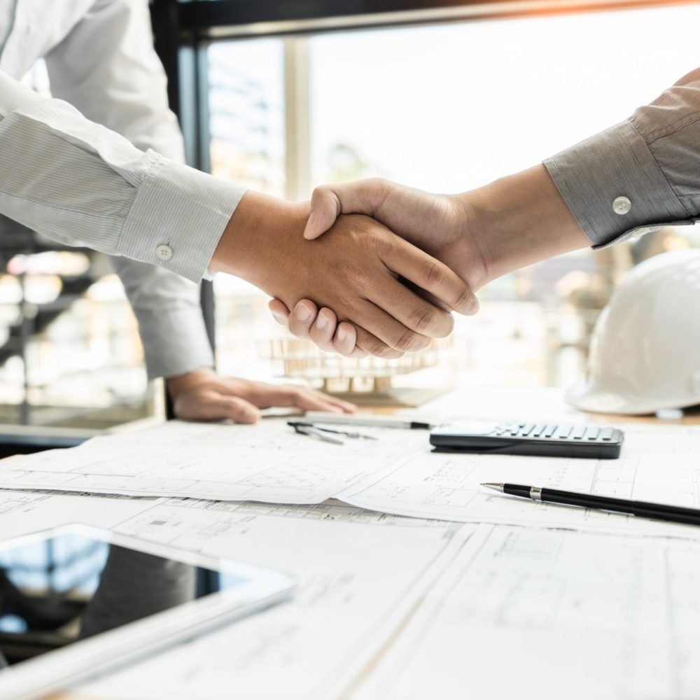 Architect,And,Engineer,Construction,Workers,Shaking,Hands,While,Working,For