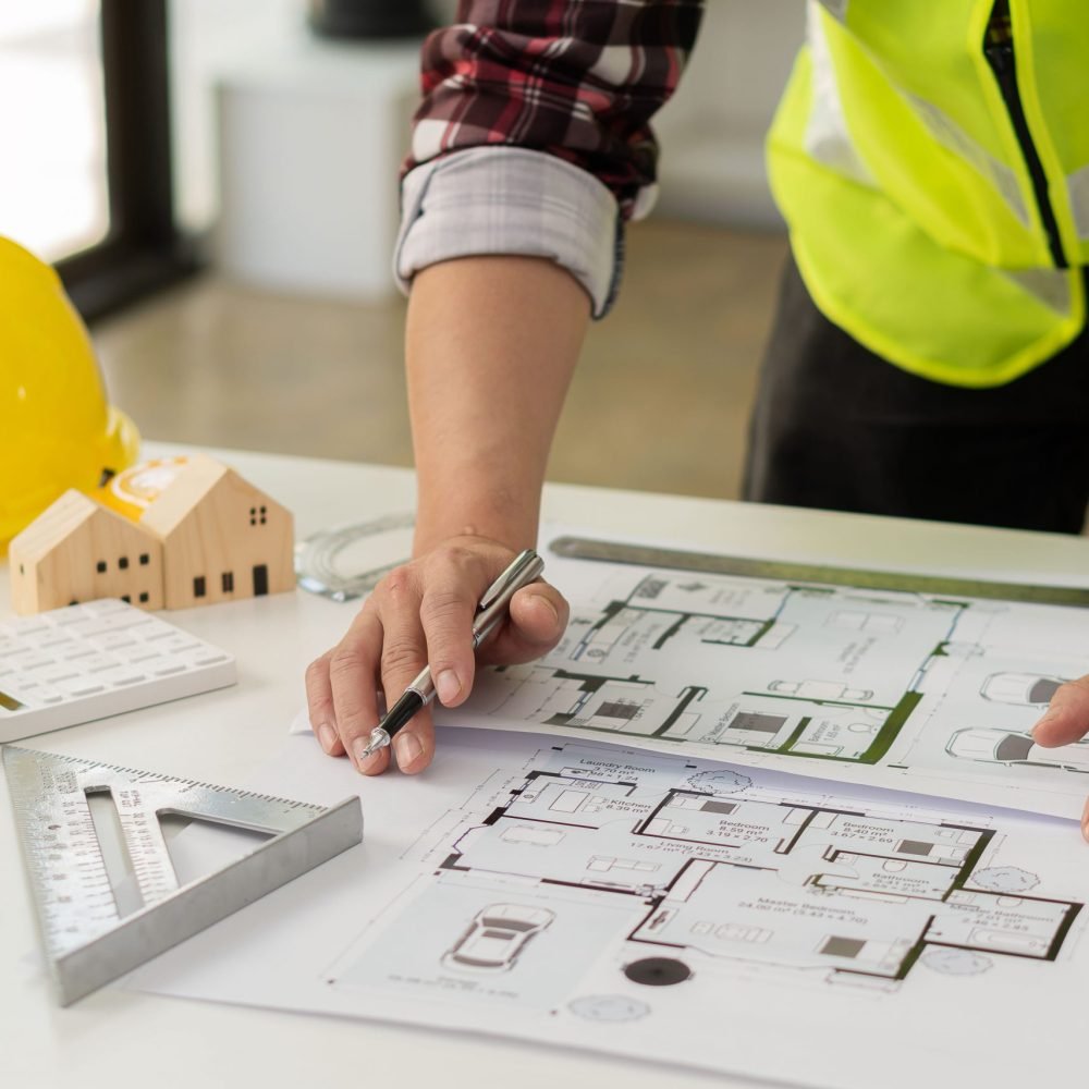 Professional,Architect,Working,On,Blueprints,And,Construction,Plans.,Building,Engineers